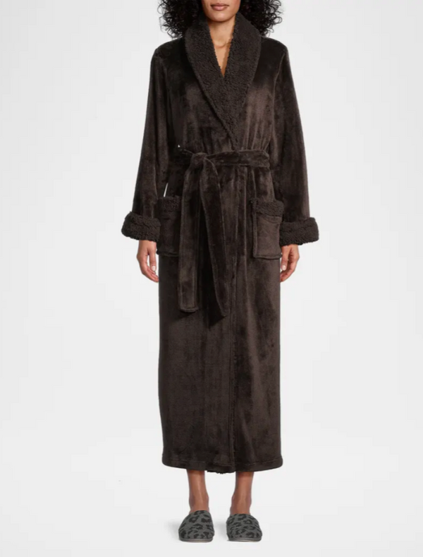 Person wearing a dark brown robe on a white background